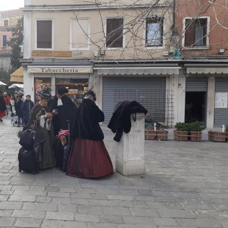 Venetian masks wandering and getting lost in Venice